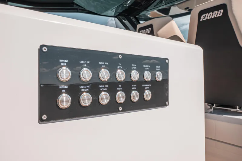 Slide: The Image of Control panel on 2026 Fjord 490 SPORT boat, featuring various function buttons. - 35