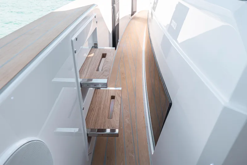 Slide: The Image of 2026 Fjord 490 SPORT boat interior with sleek wooden steps and modern design. - 38