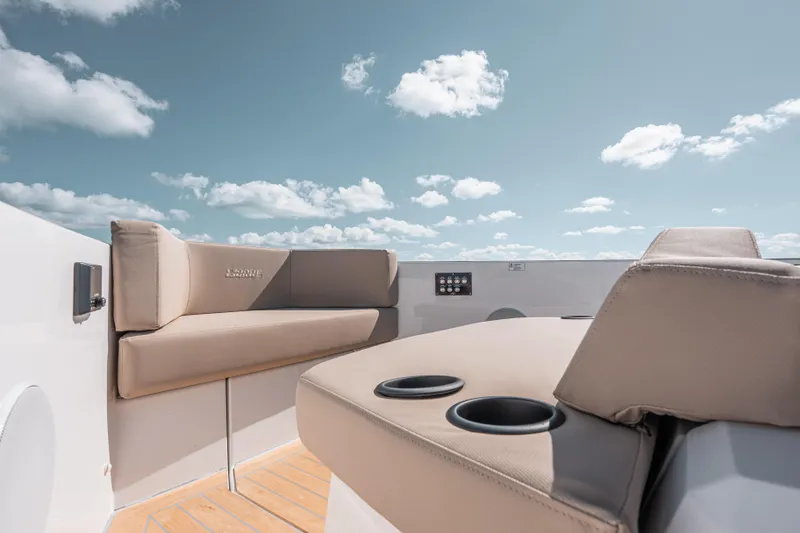 Slide: The Image of Luxurious seating on 2026 Fjord 490 SPORT boat under a clear blue sky. - 39