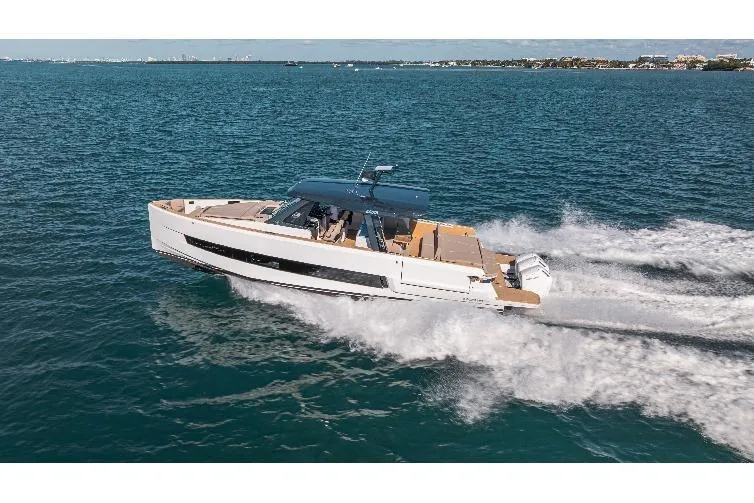 Slide: The Image of 2026 Fjord 490 SPORT yacht cruising on open water, showcasing sleek design and performance. - 4