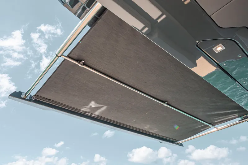 Slide: The Image of Fjord 490 SPORT 2026 yacht awning against a bright blue sky. - 40