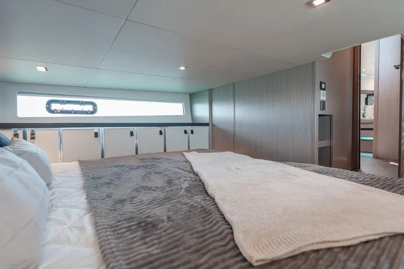 Slide: The Image of Luxurious interior cabin of 2026 Fjord 490 SPORT yacht, featuring modern design and cozy bedding. - 47