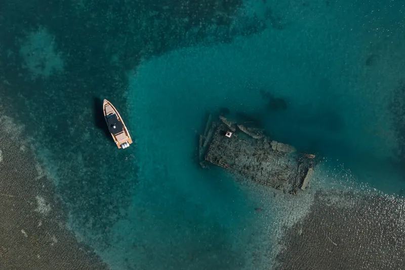 Slide: The Image of Aerial view of 2026 Fjord 490 SPORT near a submerged shipwreck in clear blue waters. - 49