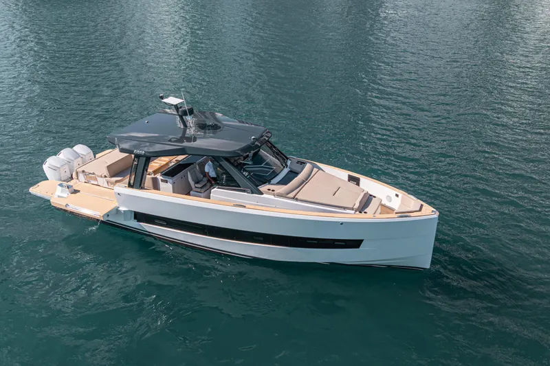 Slide: The Image of 2026 Fjord 490 SPORT luxury boat cruising on clear blue water. - 6
