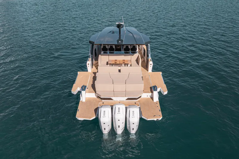 Slide: The Image of 2026 Fjord 490 SPORT luxury boat with triple engines on open water. - 9