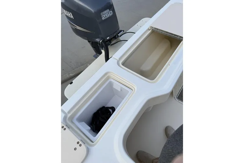 Slide: The Image of 2010 Parker 2510 XL Walkaround boat with Yamaha 250 engine, featuring storage compartments. - 10