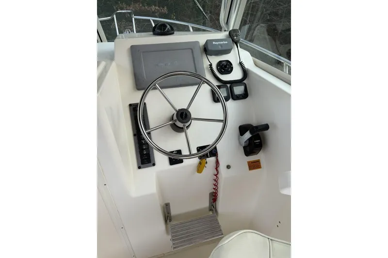 Slide: The Image of Steering console of a 2010 Parker 2510 XL Walkaround boat with navigation equipment. - 6
