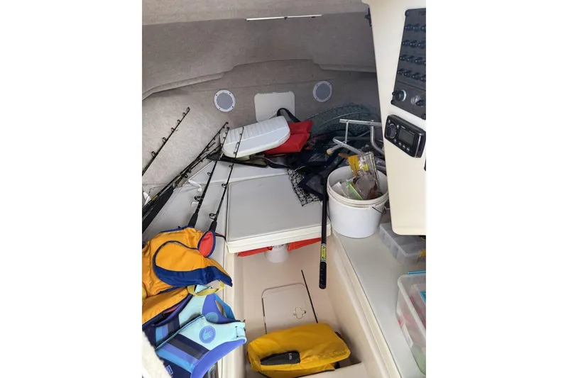 Slide: The Image of Interior of 2010 Parker 2510 XL Walkaround with fishing gear and life jackets. - 8