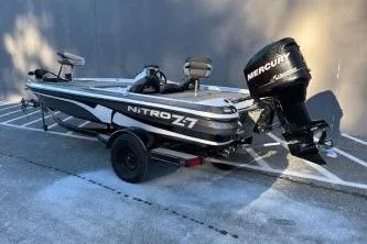 Slide: The Image of 2008 Nitro Z-7 boat with Mercury engine, parked on a trailer in a lot. - 3