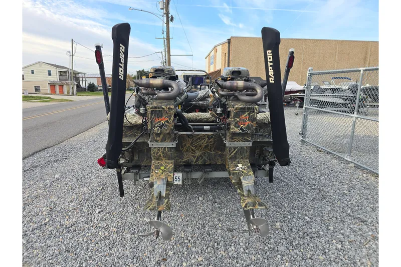 Slide: The Image of Rear view of 2023 Go-Devil 2072 boat with dual Raptor motors on gravel. - 11