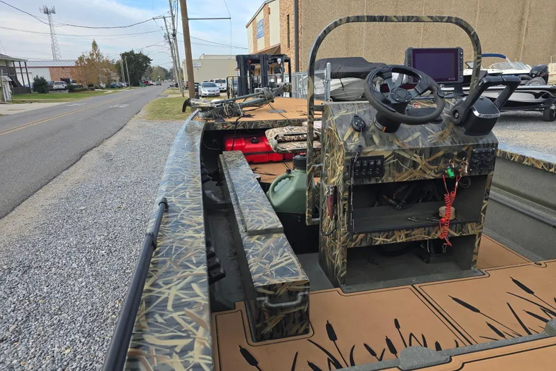 Slide: The Image of 2023 Go-Devil 2072 boat with camouflage design, parked on a gravel road. - 19