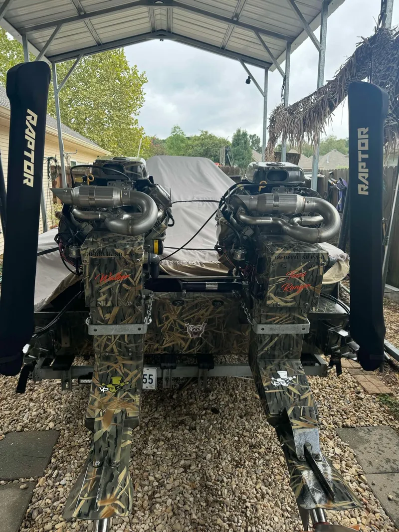 Slide: The Image of 2023 Go-Devil 2072 boat on trailer, camouflaged design, parked outdoors. - 4