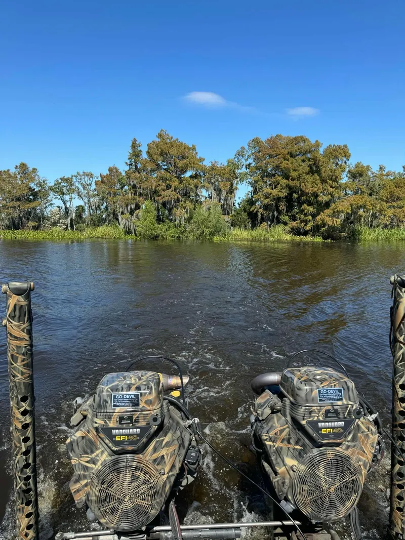 Slide: The Image of 2023 Go-Devil 2072 boat on sandy riverbank under clear blue sky. - 6