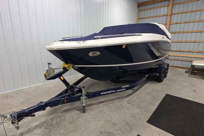 Slide: The Image of 2023 Regal LS4 boat on trailer in indoor storage facility. - 1
