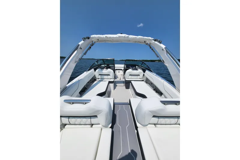 Slide: The Image of 2023 Regal LS4 boat interior with luxurious seating on a sunny day. - 15
