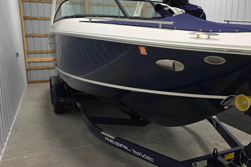 Slide: The Image of 2023 Regal LS4 boat in storage on trailer. - 2