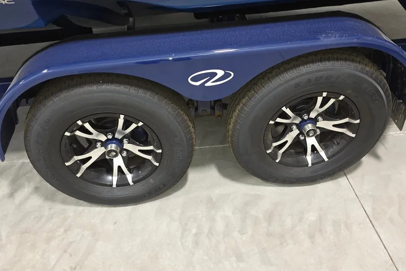 Slide: The Image of 2023 Regal LS4 trailer wheels with stylish black and silver rims on concrete floor. - 22