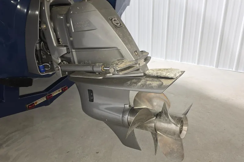 Slide: The Image of 2023 Regal LS4 boat propeller and outdrive in a garage setting. - 25