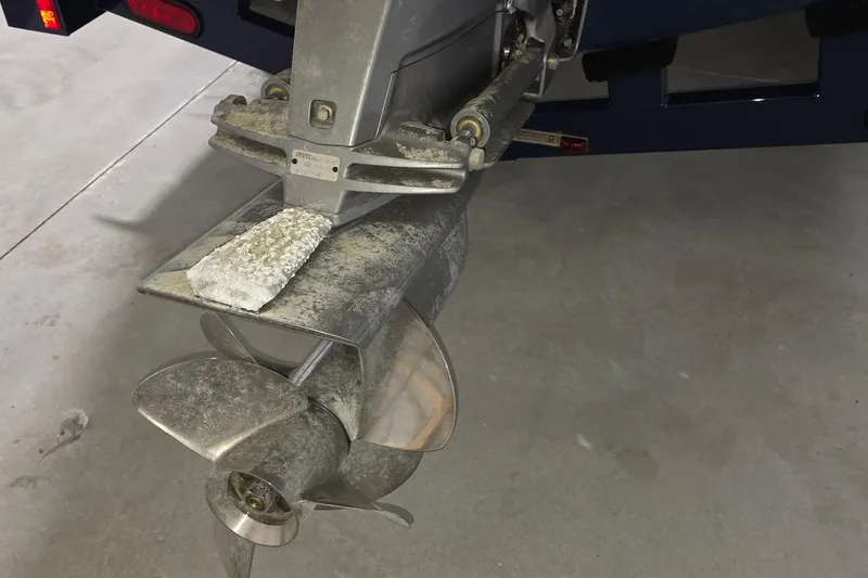 Slide: The Image of 2023 Regal LS4 boat propeller with visible wear and corrosion in a garage setting. - 26