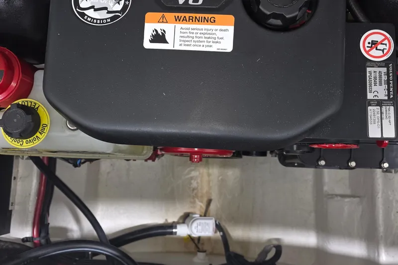 Slide: The Image of Engine compartment of 2023 Regal LS4 with warning labels and components visible. - 32