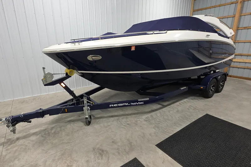 Slide: The Image of 2023 Regal LS4 boat on trailer in indoor storage facility. - 4
