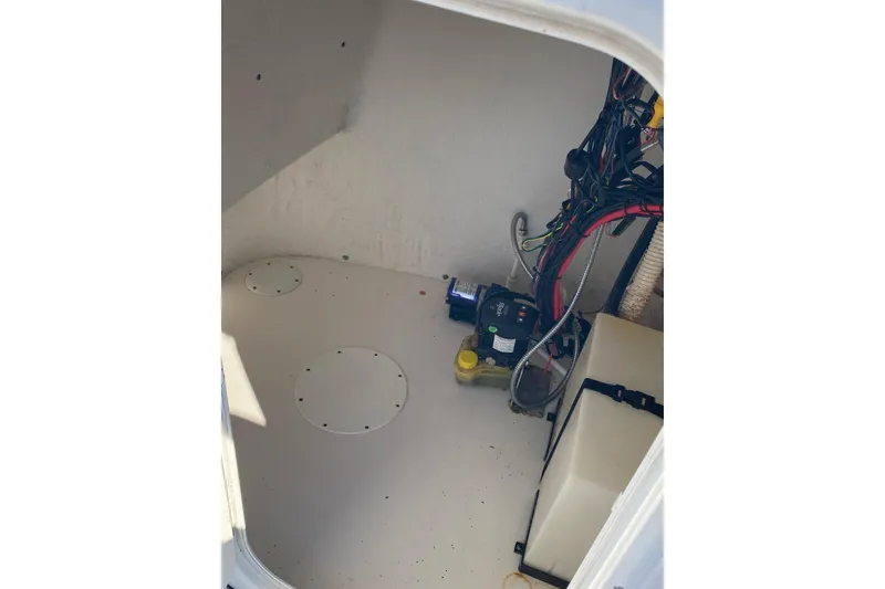 Slide: The Image of 2014 Tidewater 196 CC Adventure boat interior wiring and equipment compartment. - 7