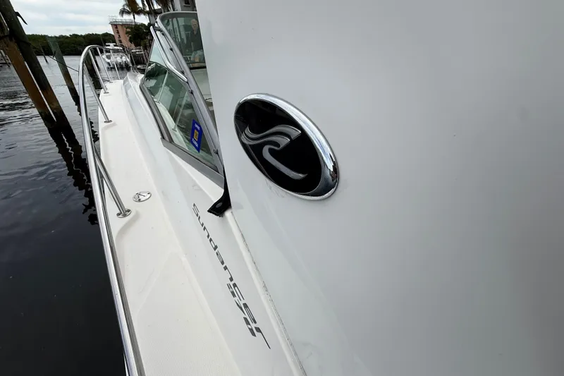 Slide: The Image of 2012 Sea Ray 370 Sundancer yacht docked, showcasing sleek design and logo. - 12