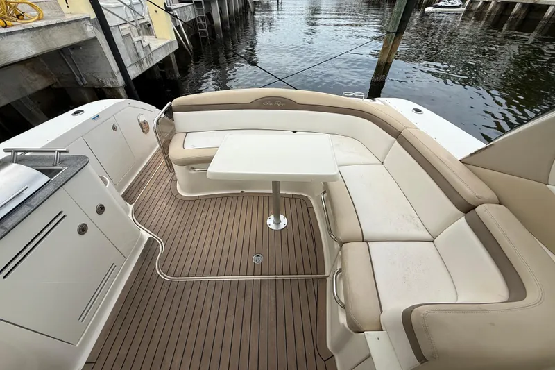 Slide: The Image of Luxurious 2012 Sea Ray 370 Sundancer boat interior with seating and table by the water. - 14