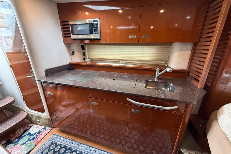 Slide: The Image of Luxurious 2012 Sea Ray 370 Sundancer yacht kitchen with sleek cabinetry and modern appliances. - 21
