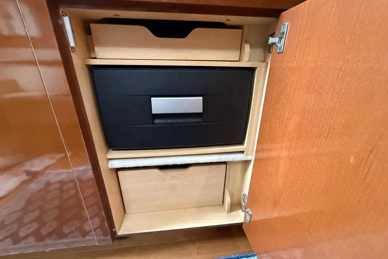 Slide: The Image of Wooden cabinet with organized storage inside a 2012 Sea Ray 370 Sundancer boat. - 22