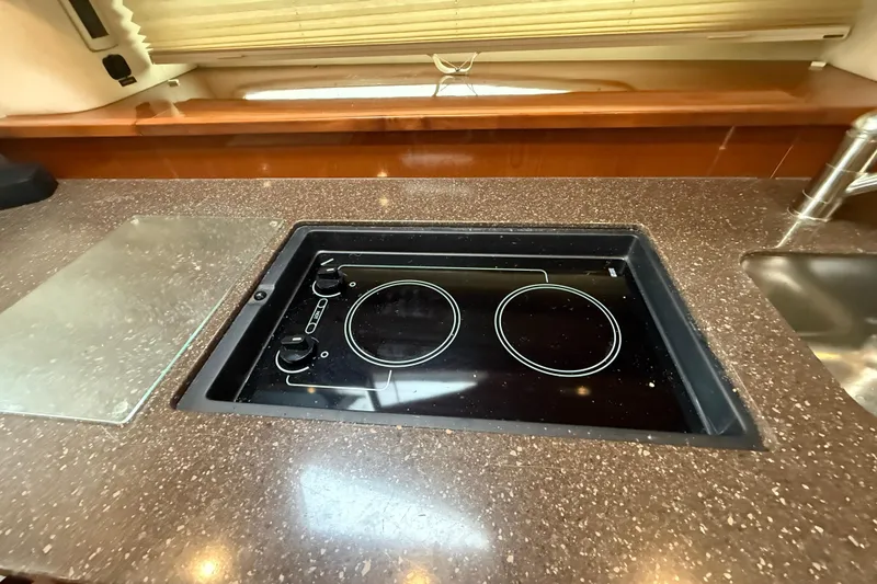 Slide: The Image of Modern kitchen area in 2012 Sea Ray 370 Sundancer yacht with electric cooktop. - 24