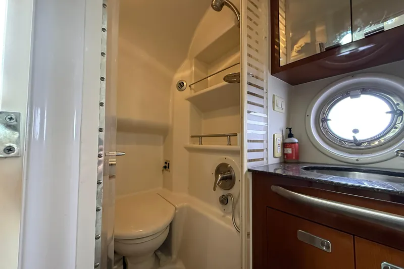 Slide: The Image of Bathroom interior of 2012 Sea Ray 370 Sundancer yacht with shower and porthole window. - 27