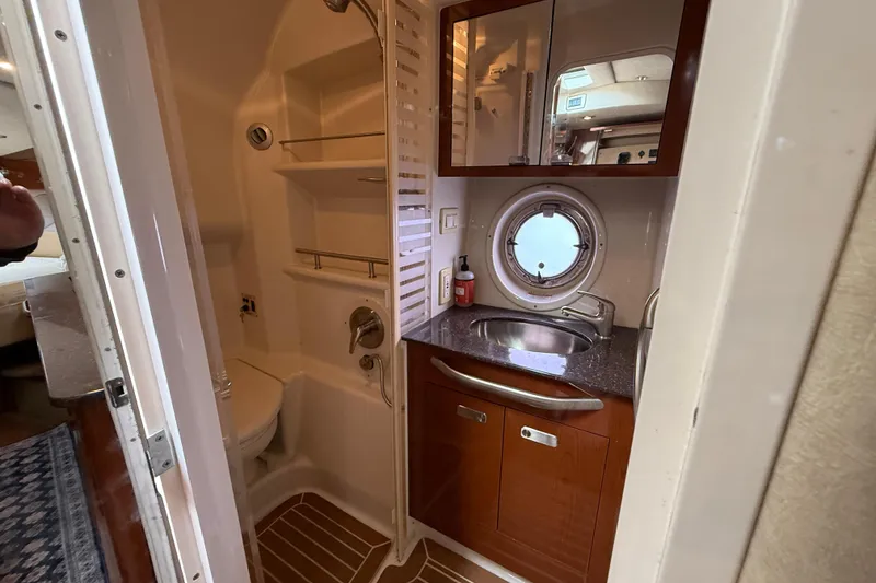 Slide: The Image of Bathroom interior of 2012 Sea Ray 370 Sundancer yacht with sink, shower, and porthole. - 28