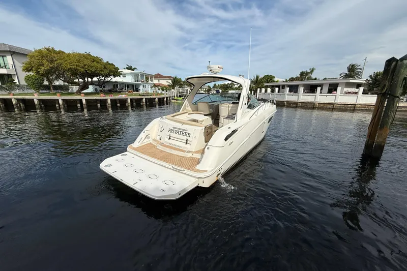 Slide: The Image of 2012 Sea Ray 370 Sundancer yacht docked in a serene waterfront setting. - 3