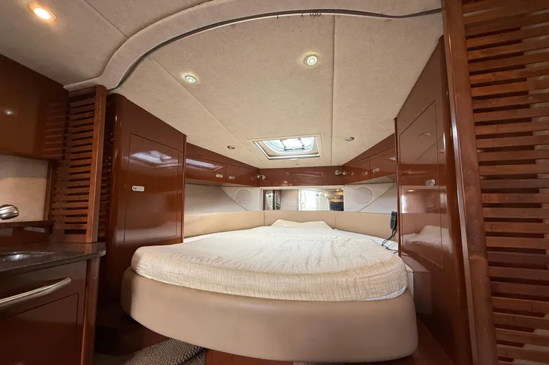 Slide: The Image of Luxurious interior cabin of 2012 Sea Ray 370 Sundancer yacht with cozy bed and wood finish. - 30
