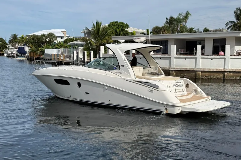 Slide: The Image of 2012 Sea Ray 370 Sundancer yacht cruising on a calm waterway. - 5