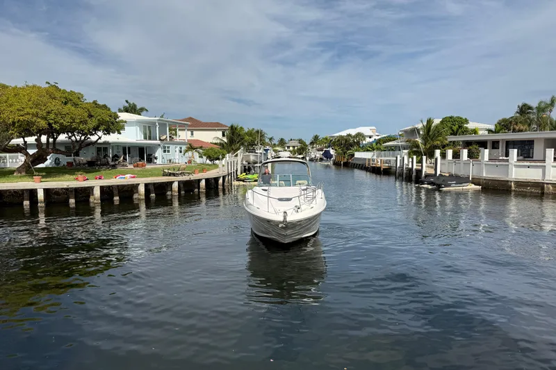 Slide: The Image of 2012 Sea Ray 370 Sundancer cruising in a scenic residential canal. - 9
