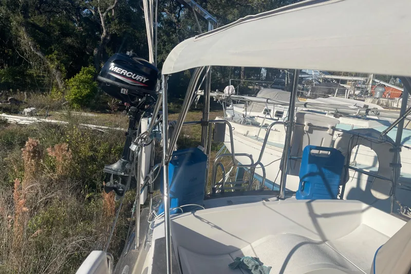 Slide: The Image of 1984 Morgan 384 sailboat with Mercury outboard motor, docked in a marina. - 10