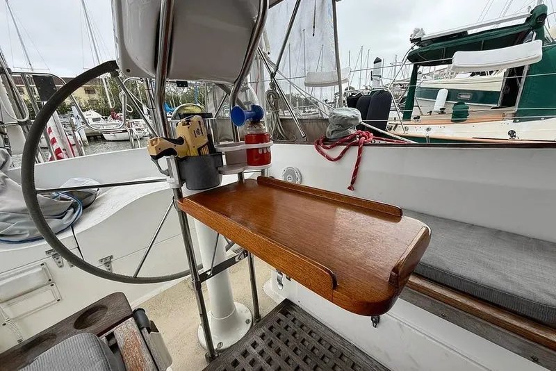 Slide: The Image of Cockpit of 1984 Morgan 384 sailboat with wooden table and steering wheel. - 22