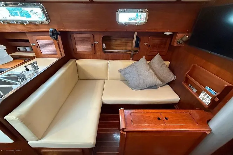 Slide: The Image of 1984 Morgan 384 yacht interior with cozy seating and wooden cabinetry. - 25