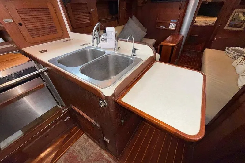 Slide: The Image of 1984 Morgan 384 yacht interior with dual sink and wooden cabinetry. - 26