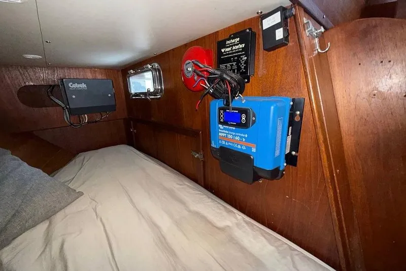 Slide: The Image of Interior of 1984 Morgan 384 sailboat with electrical equipment and cozy sleeping area. - 27