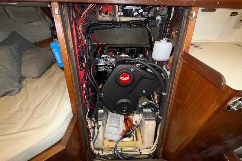 Slide: The Image of Engine compartment of a 1984 Morgan 384 sailboat, showcasing wiring and components. - 30