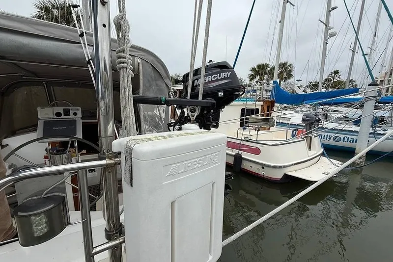 Slide: The Image of 1984 Morgan 384 sailboat with Mercury outboard motor docked in marina. - 35