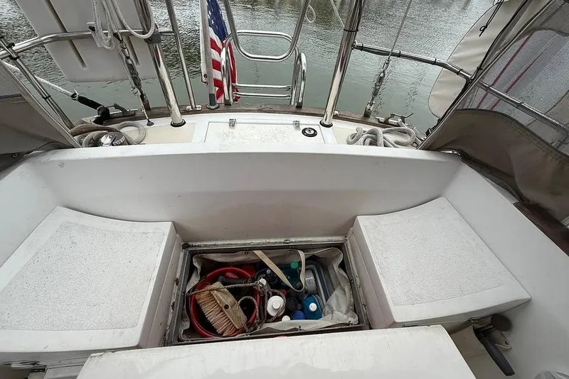 Slide: The Image of 1984 Morgan 384 sailboat cockpit with storage compartment and American flag. - 37