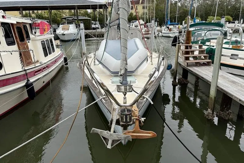 Slide: The Image of 1984 Morgan 384 sailboat docked in a marina, surrounded by other boats. - 4