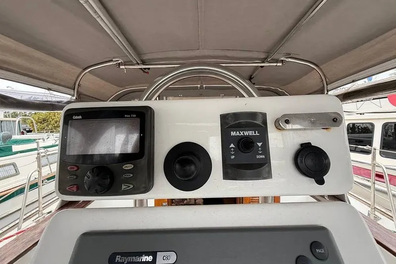 Slide: The Image of Control panel of a 1984 Morgan 384 sailboat featuring navigation and control instruments. - 42