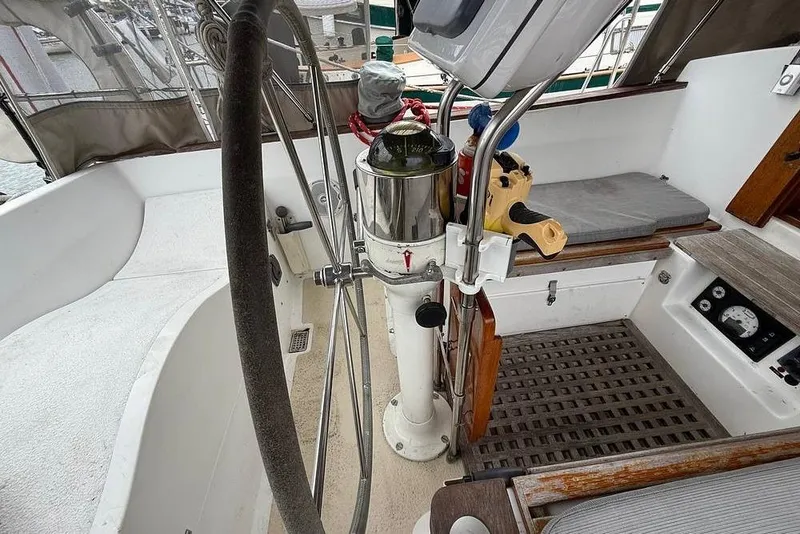 Slide: The Image of 1984 Morgan 384 yacht cockpit with steering wheel and navigation instruments. - 43