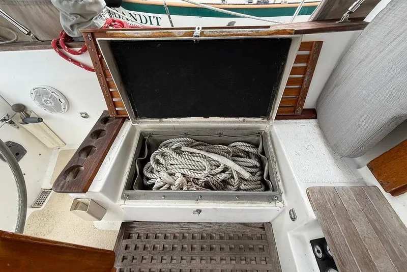 Slide: The Image of Open storage compartment on 1984 Morgan 384 sailboat, containing coiled rope. - 49