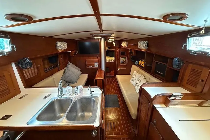 Slide: The Image of Interior of a 1984 Morgan 384 sailboat with wood finish and cozy seating area. - 53